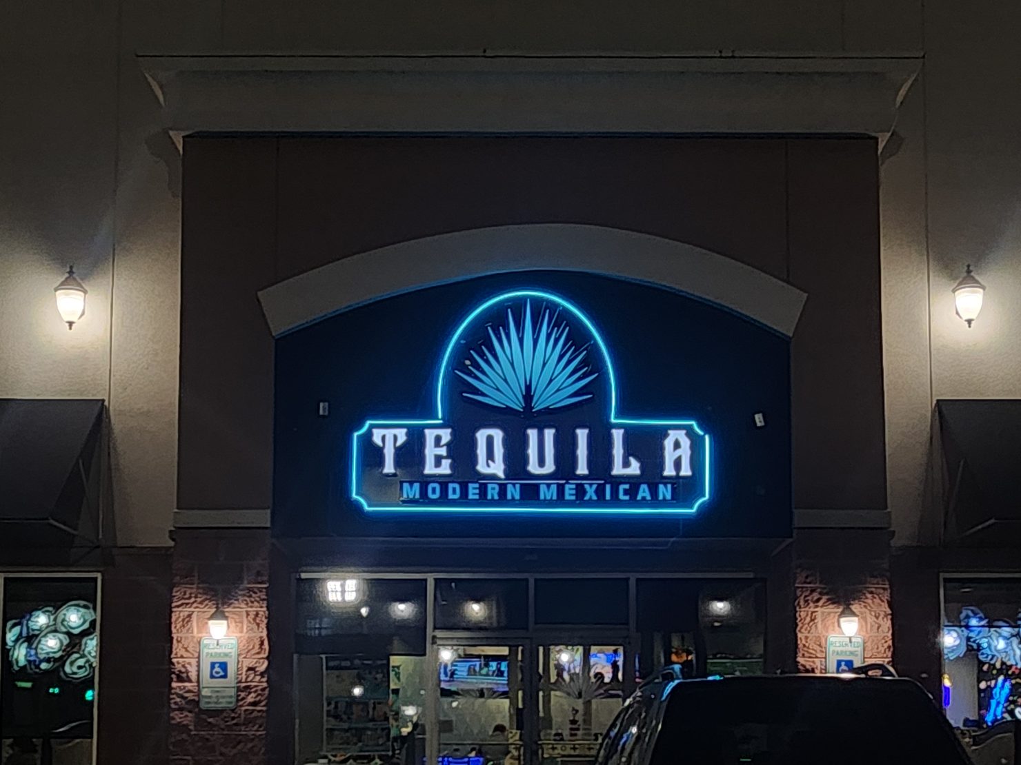 Tequila Modern Mexican illuminated storefront sign at night