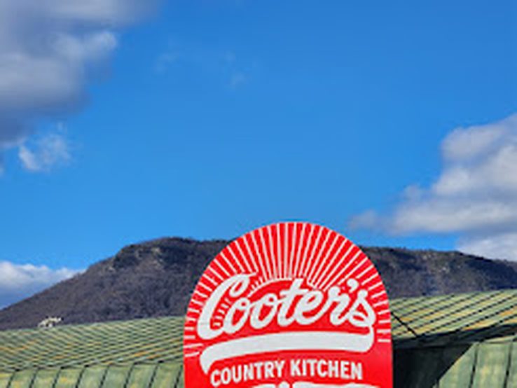 Cooter's Country Kitchen red storefront sign against the mountains